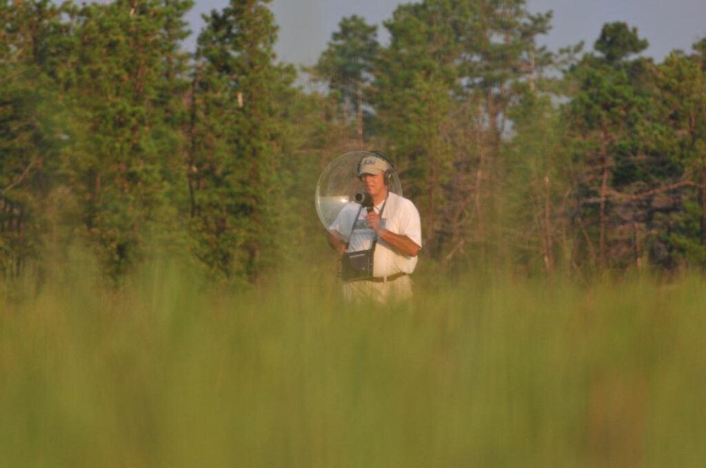 Dr. Emile DeVito performing a bird survey.